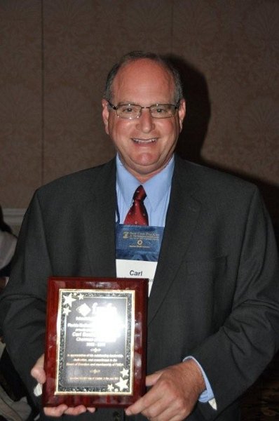 FMDA- Oct. 2011 139.jpg - Dr. Carl Suchar (left) is presented with a plaque for his dedication and work as Chairman of the Board of FMDA over the past two years.